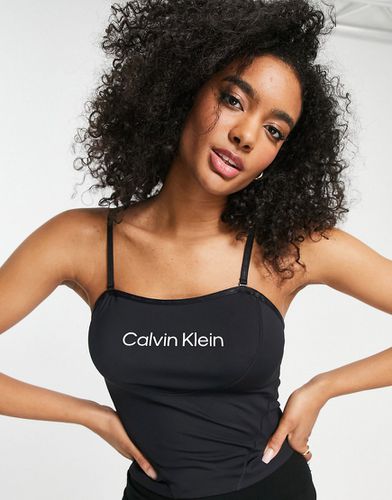 Reggiseno sportivo a canottiera nero con logo in coordinato - Calvin Klein Performance - Modalova