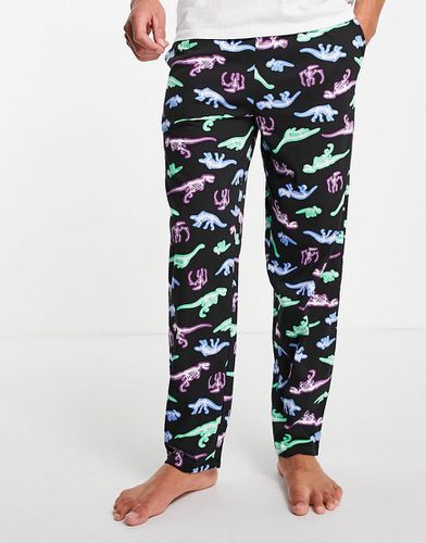 Pantaloni del pigiama da casa con stampa con dinosauri - ASOS DESIGN - Modalova